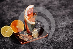 Mulled wine and spices on stone background.