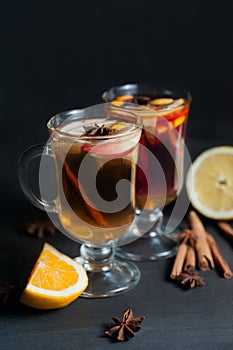 Mulled wine in white rustic mugs with spices and citrus fruits