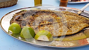 Mullet - open roasted fish lemon dish - food of west Greece
