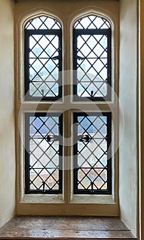 A mullioned window with leaded lights, viewed from inside at Nymans House in West Sussex