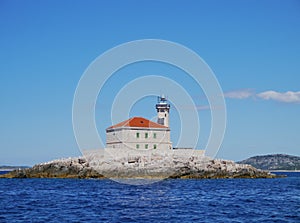 The Mulo Lighthouse in front of the Croatian coast photo