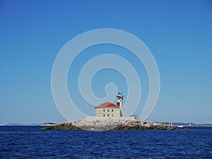 The Mulo Lighthouse in front of the Croatian coast photo