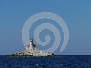 The Mulo lighthouse on a rock in the Mediterranean photo
