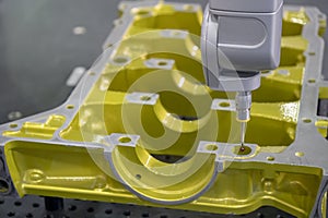 The multi-axis CMM machine measure the aluminum automotive part