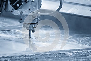 The multi-axis waterjet cutting machine cutting the aluminum plate