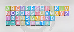 Multi-color Alphabet ABC letters and number and mathematics sign in square flat papers on white background