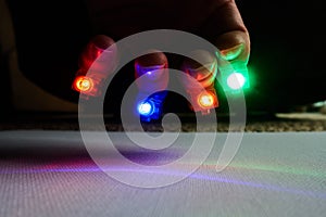 Multi-color finger lights on outstretched hand