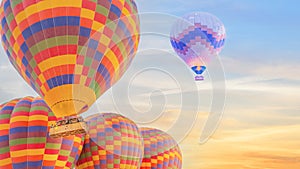 Multi color hot air balloon flying over sunrise sky