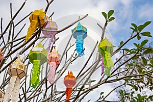 The multi-color of Lanna prayer lanterns decoration on a tree in ceremonies at a Buddhist temple.