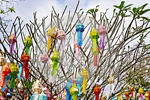 The multi-color of Lanna prayer lanterns decoration on a tree in ceremonies at a Buddhist temple.