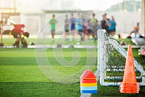 Multi color of marker cones and mini goal on green artificial turf for soccer training equipment
