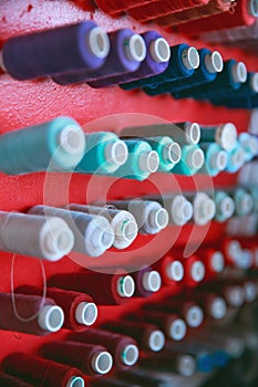 Multi color Spools of thread needlework, sewing, tailoring and tailoring industry concept