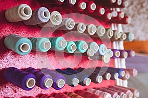 Multi color Spools of thread needlework, sewing, tailoring and tailoring industry concept