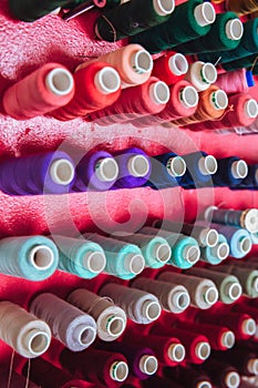 Multi color Spools of thread needlework, sewing, tailoring and tailoring industry concept