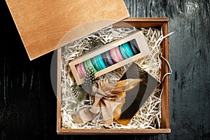 Multi-colored almond macaroni biscuits in a big gift box.