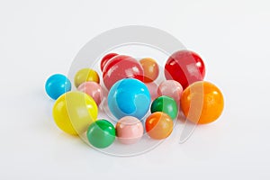 Multi colored balls of chewing gum on a white background with reflection