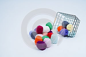 Multi-colored balls of thread.