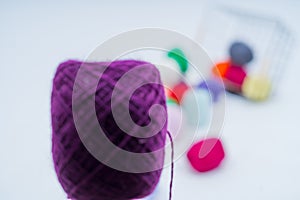 Multi-colored balls of thread.