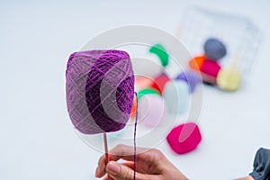 Multi-colored balls of thread.