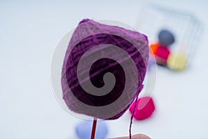 Multi-colored balls of thread.