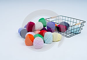 Multi-colored balls of thread.