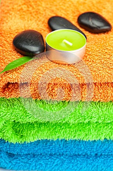 Multi-colored bath towels, black spa sto