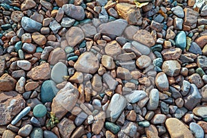 Multi colored beach stones on the shore of Lake Superior, background, texture