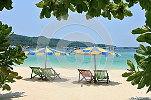 Multi-colored beach umbrellas and chaise lounges