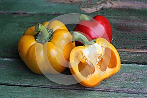 Multi-colored bell peppers on the background of boards