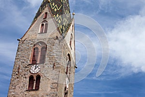 The multi colored bell tower of the church of Villandro in Val Isarco, Italy photo