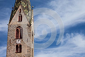 The multi colored bell tower of the church of Villandro in Val Isarco, Italy photo