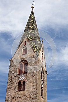 The multi colored bell tower of the church of Villandro in Val Isarco, Italy photo