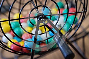 Multi-colored Bingo balls in a cage.