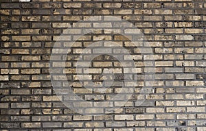 Multi-colored brick wall close-up, texture, uneven surface, background