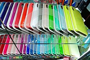 Multi-colored cases for the smartphone on a shop window. Choosing case for your smartphone.