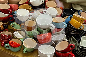 Multi-colored ceramic mugs on the counter