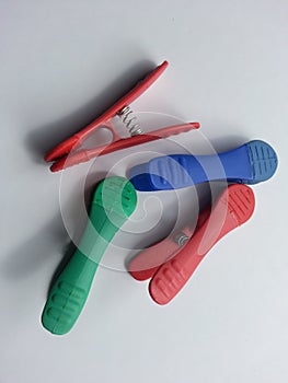 Multi colored chip clips on white background