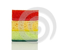 Multi-colored cleaning sponges. Bright helpers in the kitchen. Close-up. Isolated on white background