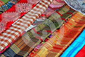 Multi-colored cloth on the counter of the store. Laos