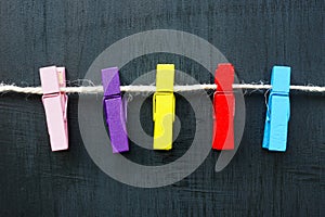 Multi-colored clothespins on a rope as a concept for diversity.