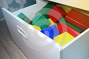 Multi-colored cubes in a drawer of a wardrobe in a children's room