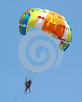 A multi-colored dome of a parachute in the sky as a background