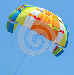 A multi-colored dome of a parachute in the sky as a background