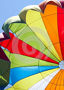 A multi-colored dome of a parachute in the sky as a background