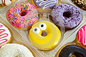 Multi-colored donuts on the table happy party