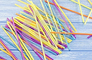 Multi-colored drinking straws on a blue background straw