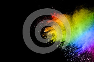 Multi colored dust splash on black background.Painted Holi.Colorful background of pastel powder explosion photo