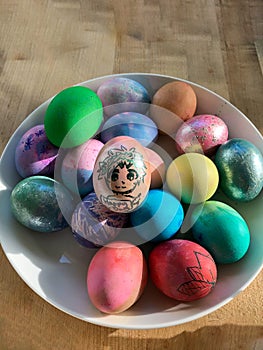 Multi-Colored Dyed Easter Eggs on a Wooden Table.