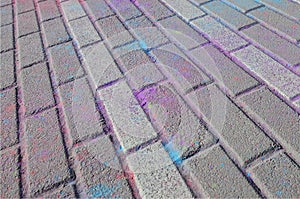 Multi colored paving slabs, powder coated with dry colors at the Holi festival photo