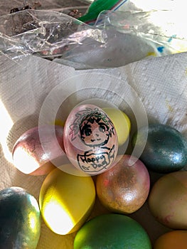 Multi-Colored Easter Eggs in a Paper Towel Lined Bowl